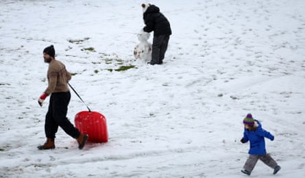 People play in first snow of the winter season in Nyack, New York, on Sunday.