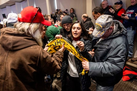 People remove a climate protester