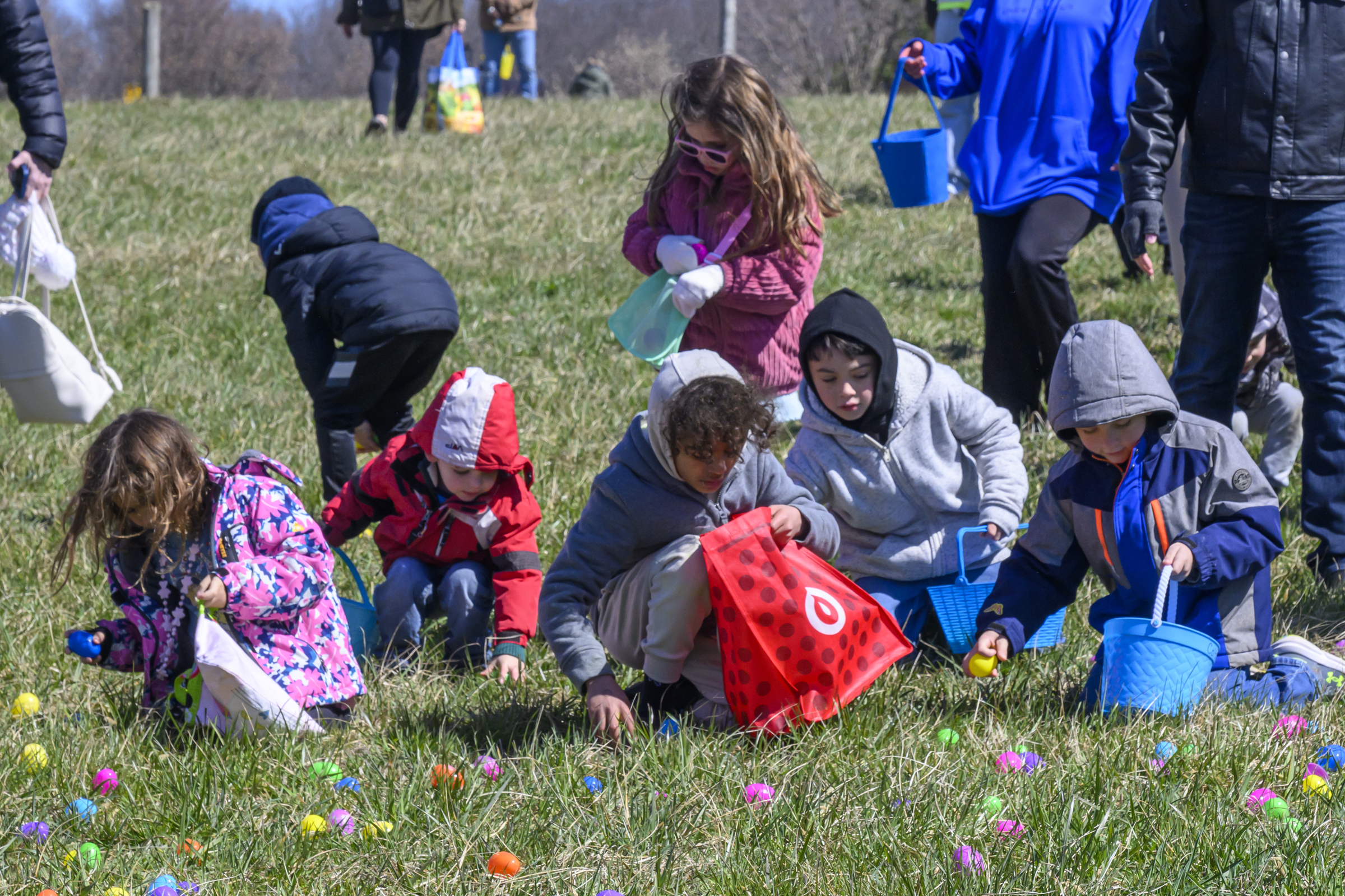 A group of children pick up Easter eggs during the Coppermine Eggstravaganza at Cascade Park in Hampstead. (Thomas Walker/Freelance)