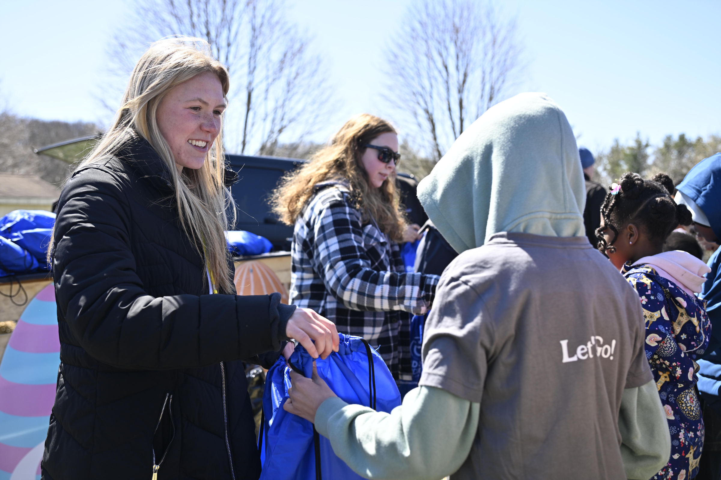Gracee Weinreich hands out gift bags during the Coppermine Eggstravaganza at Cascade Park in Hampstead. (Thomas Walker/Freelance)