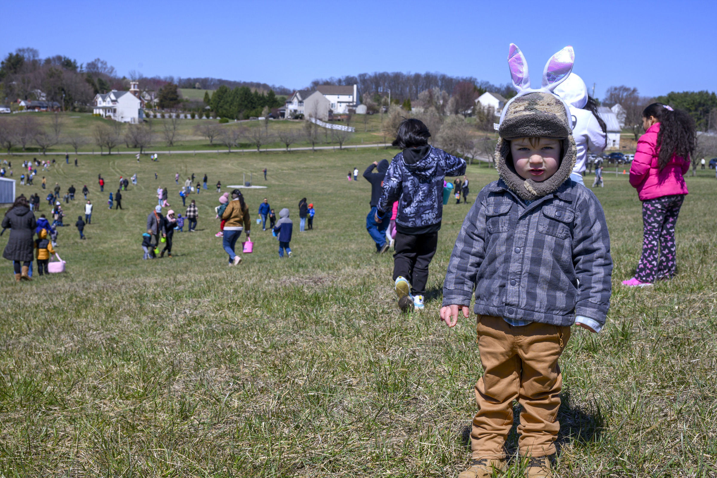 T.J. Burkins, 3, wears rabbit ears while searching for Easter eggs during the Coppermine Eggstravaganza at Cascade Park in Hampstead. (Thomas Walker/Freelance)