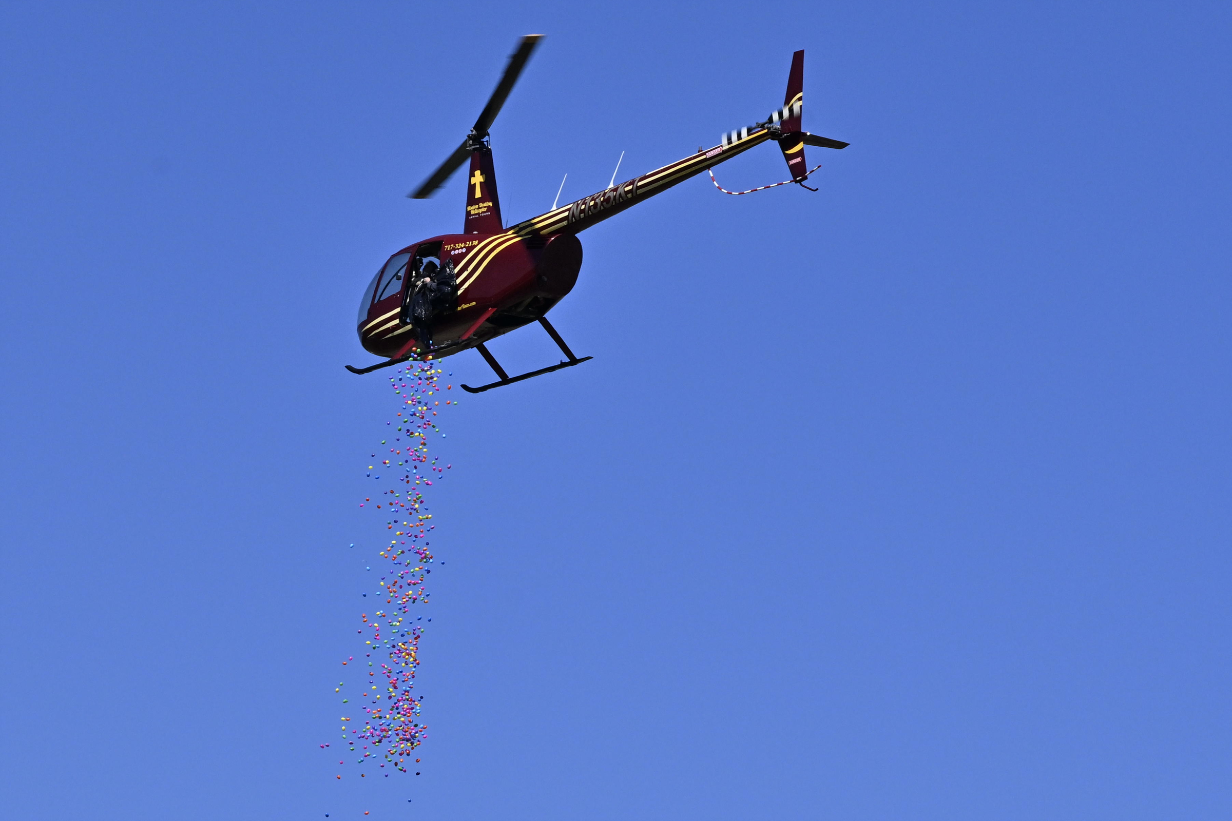 Plastic eggs pour from a helicopter during the Coppermine Eggstravaganza at Cascade Park in Hampstead. (Thomas Walker/Freelance)
