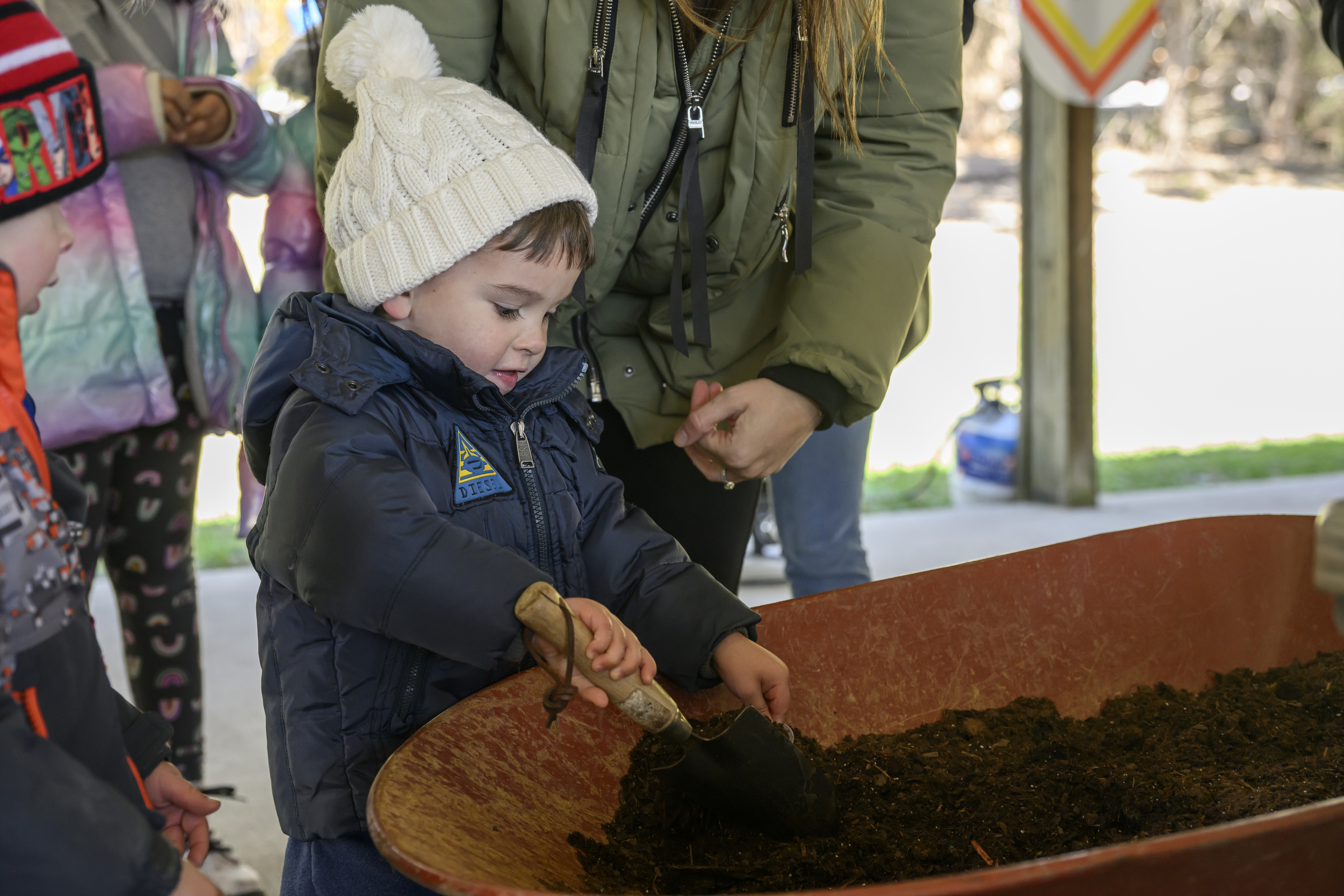 Luca Echavarria,3, gathers dirt to plant a flower during the Coppermine Eggstravaganza at Cascade Park in Hampstead. (Thomas Walker/Freelance)
