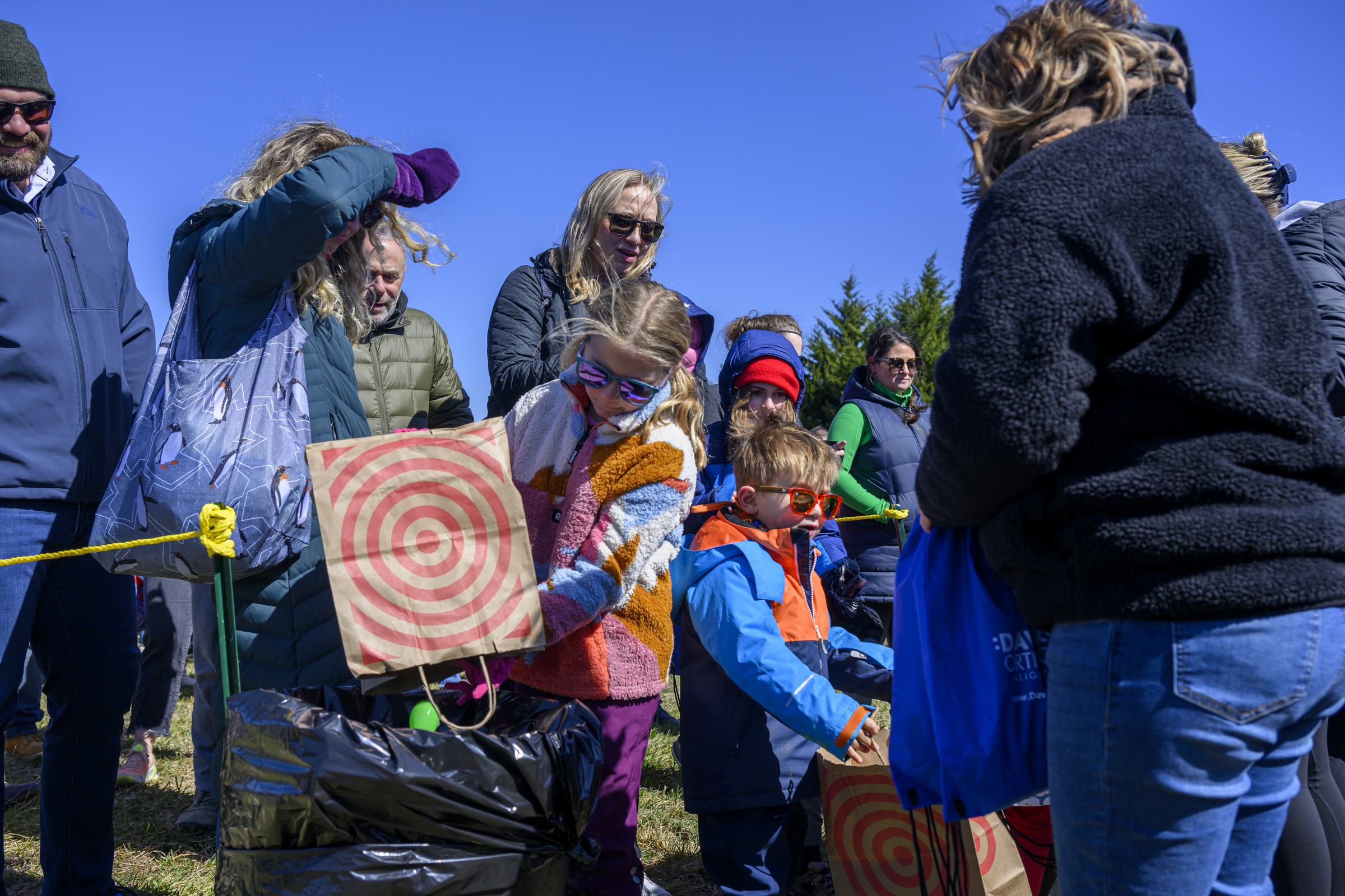 Clara Clark puts her eggs into a collectiton bin before receiving her gift bag during the Coppermine Eggstravaganza at Cascade Park in Hampstead. (Thomas Walker/Freelance)