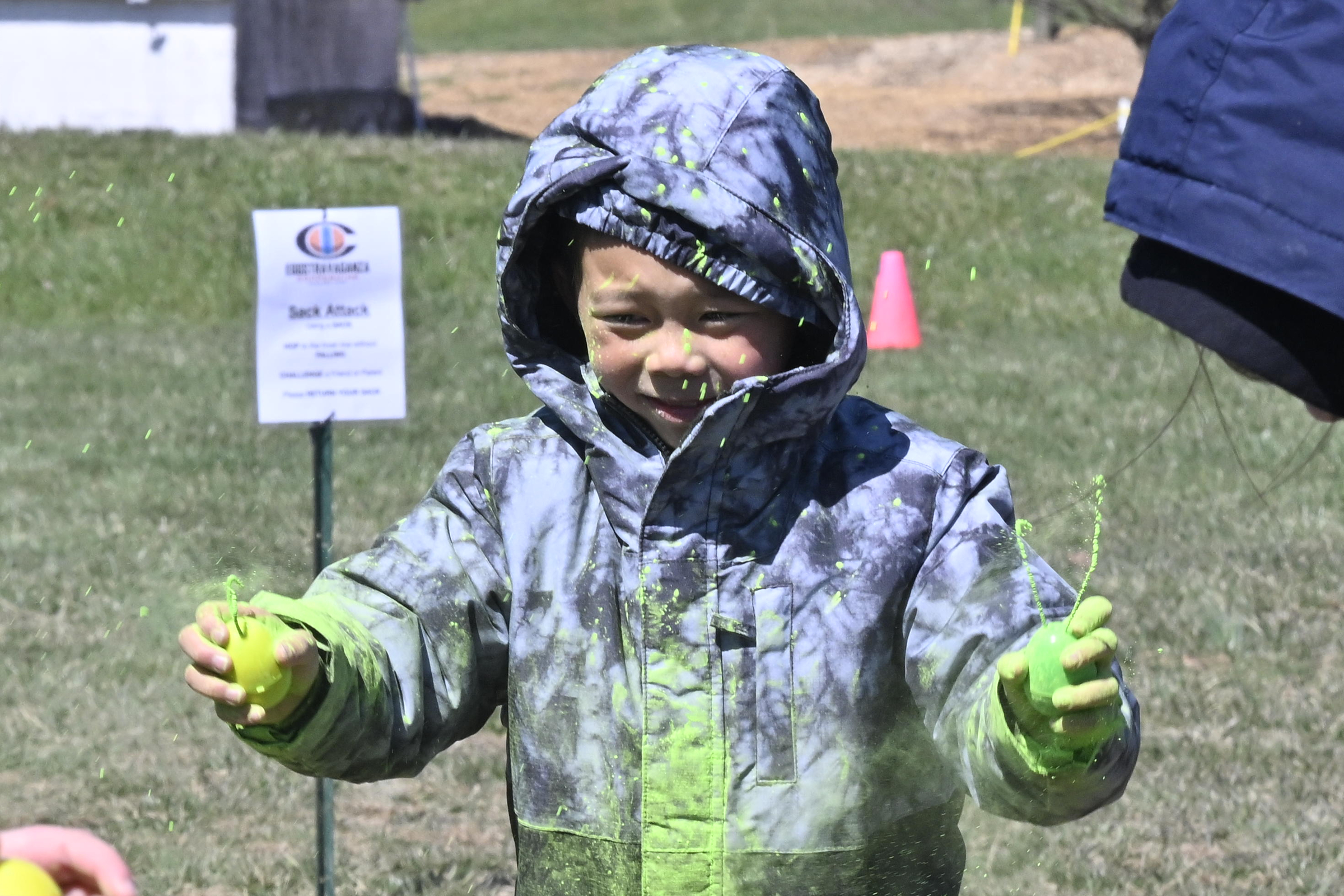 Micah Lin, 7, plays with powdered filled plastic eggs during the Coppermine Eggstravaganza at Cascade Park in Hampstead. (Thomas Walker/Freelance)