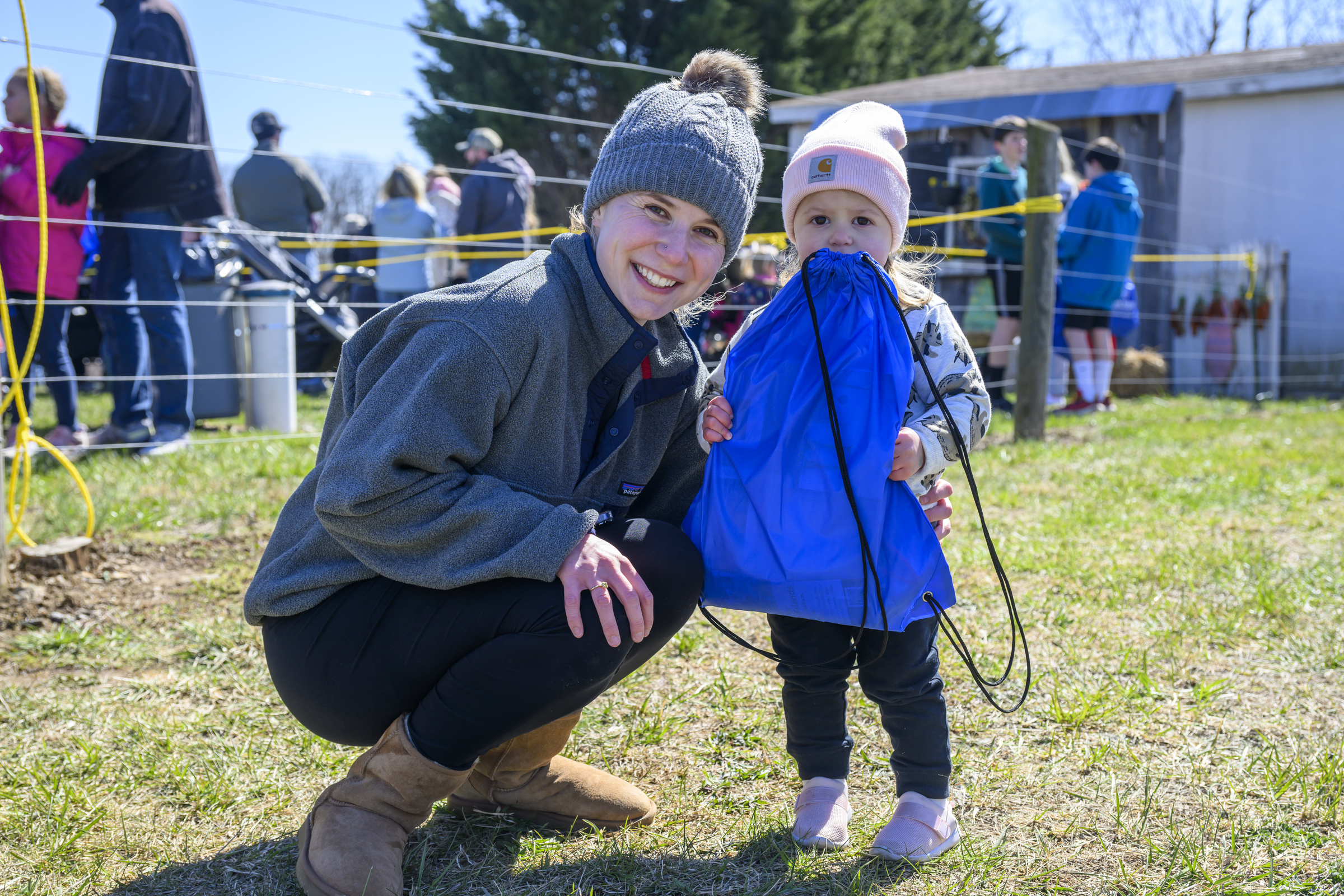 Katie Bogash smiles as her daughter Payton holds on tightly to her gift bag during the Coppermine Eggstravaganza at Cascade Park in Hampstead. (Thomas Walker/Freelance)