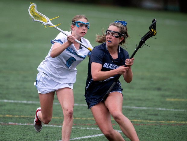 March 27, 2024: Notre Dame Prep’s Lily Peek, right, moves...