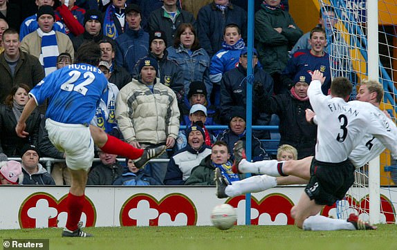 Portsmouth's Richard Hughes (L) scores the winning goal past Liverpool's Steve Finnan (2L) and Stephane Henchoz of Switzerland during their English FA Cup fifth round replay soccer match at Fratton Park, Portsmouth, February 21, 2004. Portsmouth won the match 1-0.  NO ONLINE/INTERNET USAGE WITHOUT A LICENCE FROM THE FOOTBALL DATA CO LTD.  FOR LICENCE ENQUIRIES PLEASE TELEPHONE +44 207 298 1656.   REUTERS/Gerry Penny
