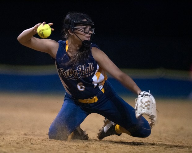 Perry Hall third baseman Shalimar Lopez throws to first after...