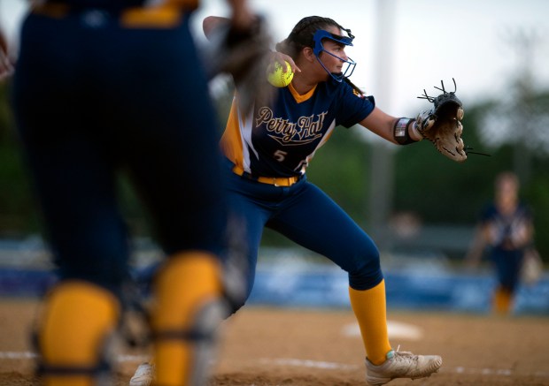 Perry Hall pitcher Jenna Neff throws to first after fielding...