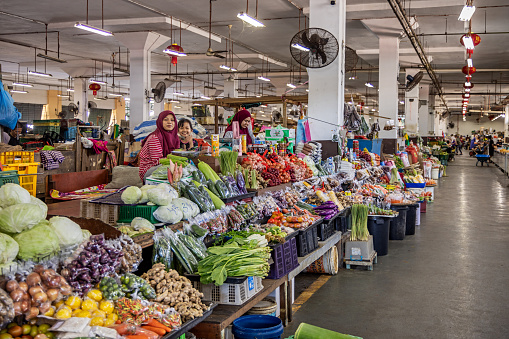 Female greengrocers in a market hall