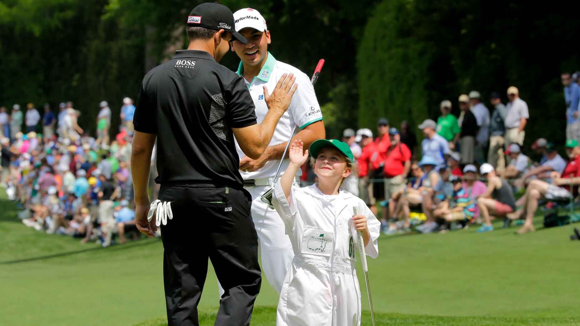 Pro golfer high-fives child at Masters Par-3 Contest