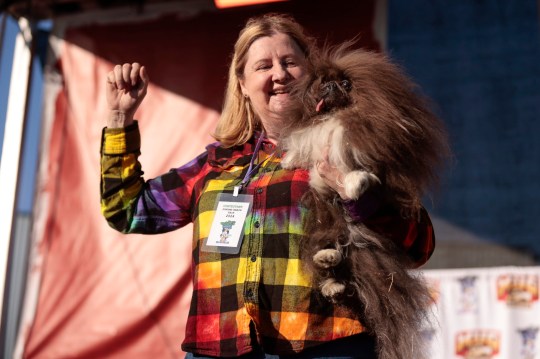 epaselect epa11429647 Wild Thang, an eight-year-old Pekingese and his owner, Anne Lewis on stage after being annouced as the first place winner during the 2024 World???s Ugliest Dog Contest at the Sonoma-Marin Fair in Petaluma, California, USA, 20 June 2024. The World's Ugliest Dog Contest has been going strong for over 30 years and is a testament that the pedigree does not define the pet. This world-renowned annual event celebrates the imperfections that make all dogs special and unique. EPA/JOHN G. MABANGLO