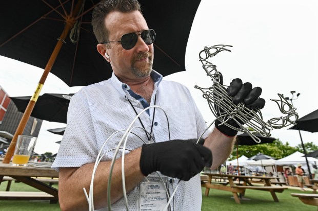 Towson free hand wire artist Devin Mack makes a crab sculpture using about 30 feet of 8 gauge aluminum wire at the Baltimore County's Arts & Drafts Summer Music and Arts festival. The free two-day event presented by the nonprofit Baltimore County Arts Guild (BCAG) features curated artist vendors, live music, fun activities for all ages and specialty food & beers from host sponsor, Guinness Open Gate Brewery. (Kenneth K. Lam/Staff)