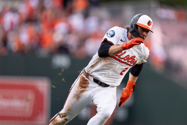 Baltimore Orioles' Gunnar Henderson advances toward home plate to score...