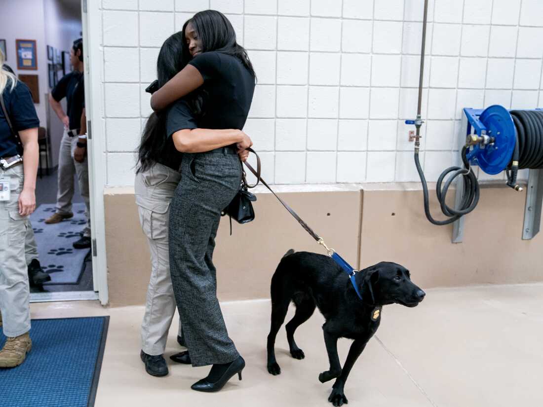 Special Agent Mariah Maye hugs her friend Jazmine Wright following a graduation ceremony for Bureau of Alcohol, Tobacco, Firearms and Explosives (ATF) Special Agent Canine Handlers and their dogs at the ATF training facility in Front Royal, Va., on Friday.