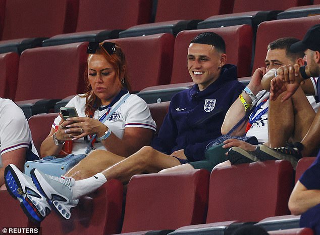 Foden is pictured smiling in the stands sitting with family after England's 0-0 on Tuesday