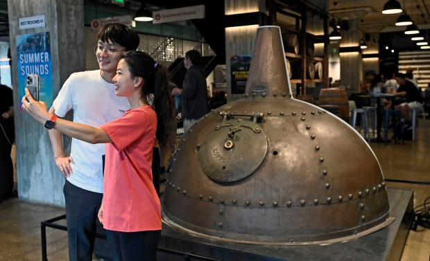 Hugh Shen takes selfie with wife Eva Lee with portion of Copper used by Guinness in its Dublin Ireland brewery in the early 1900s. Tours of the new brewery and bar/restaurant is part of Baltimore County's Arts & Drafts Summer Music and Arts festival. The free two-day event presented by the nonprofit Baltimore County Arts Guild (BCAG) features curated artist vendors, live music, fun activities for all ages and specialty food & beers from host sponsor, Guinness Open Gate Brewery. (Kenneth K. Lam/Staff)