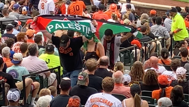 Four fans at Camden Yards who protested to support Palestine...