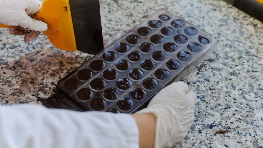 ChoViva chocolate, which is a cocoa-free chocolate alternative, is being tested and processed by an employee at the testing lab of Planet A Foods.