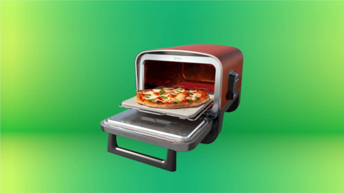 Ninja woodfire pizza oven against a green background.