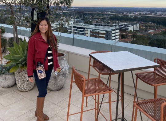 Linda Loprasert stood on a rooftop overlooking a city