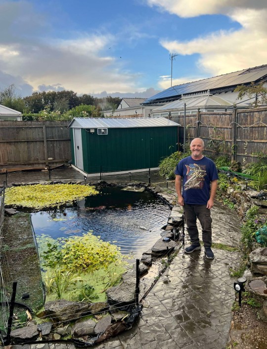 Nigel next to his pond (Picture: Nigel Cooper/SWNS)