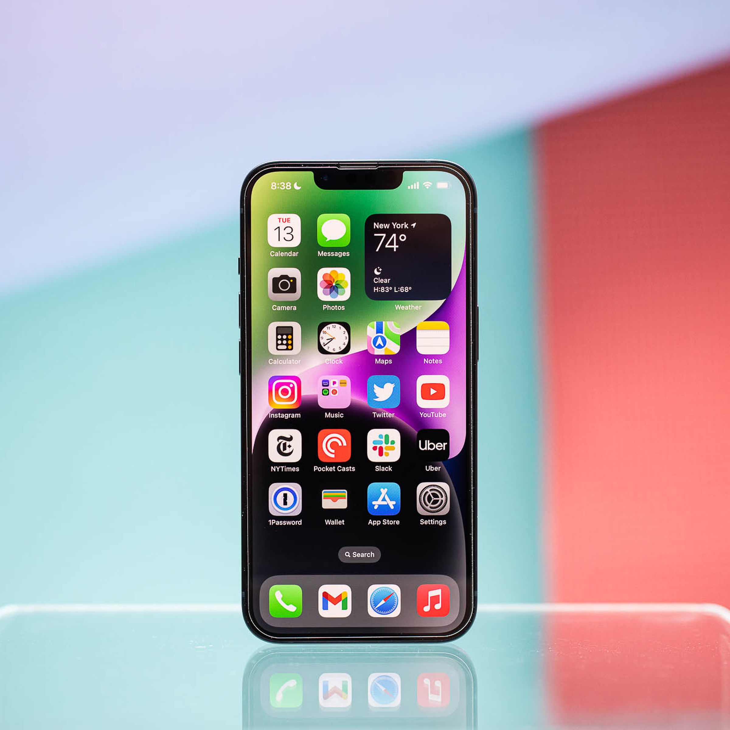 An iPhone 14 sitting upright on a table.