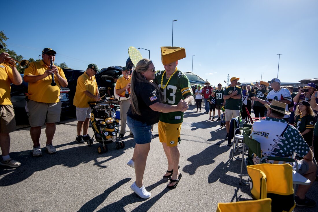 Packers fans Heather Gunnlaugsson, left, and Tim Mahoney, right, dance as the Packer Tailgate Band plays “Roll Out the Barrel” on Sunday, Sept. 29, before the Packers’ game against the Minnesota Vikings in Green Bay, Wis.