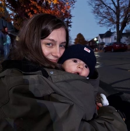 A woman carrying a baby