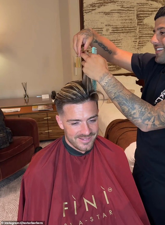 Manchester City star Jack Grealish smiles as he gets a trim from Alsanawi over the summer