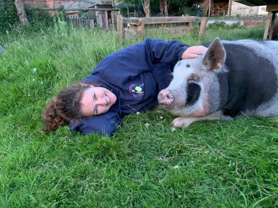 Colin and Hannah lying on the grass together.