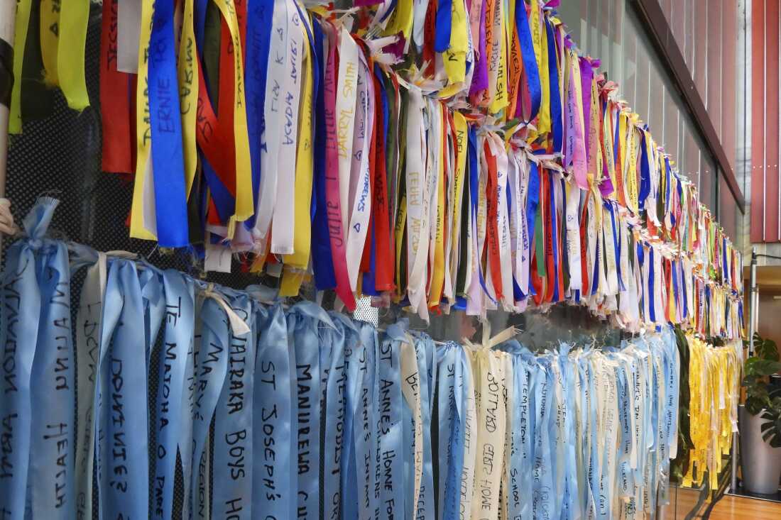 Ribbons are displayed on a wall at Parliament House in Wellington, New Zealand, ahead of the apology to the survivors of abuse in state, faith-based and foster care over a period of seven decades.