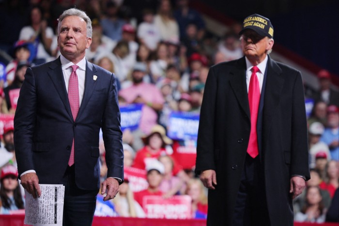 Businessman Steve Witkoff stands on stage with Donald Trump during a campaign rally in Macon, Georgia, on November 3 2024