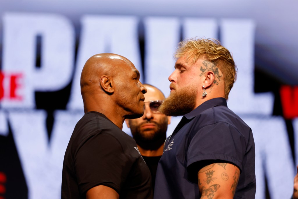 NEW YORK, NEW YORK - MAY 13: (L-R) Mike Tyson and Jake Paul speak onstage at the press conference in promotion for the upcoming Jake Paul vs. Mike Tyson boxing match at The Apollo Theater on May 13, 2024 in New York City. (Photo by Sarah Stier/Getty Images for Netflix)