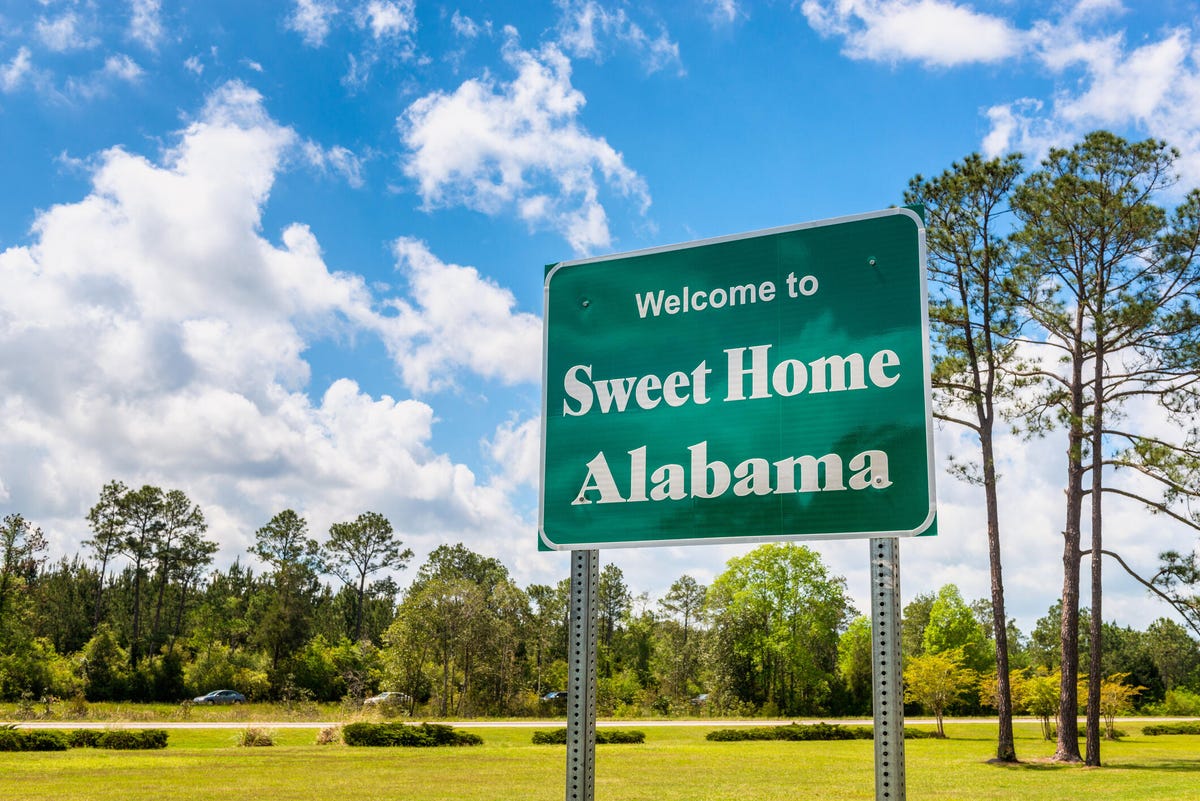 Welcome to Sweet Home Alabama road sign along Interstate 10 in Alabama, near the state border with Florida.