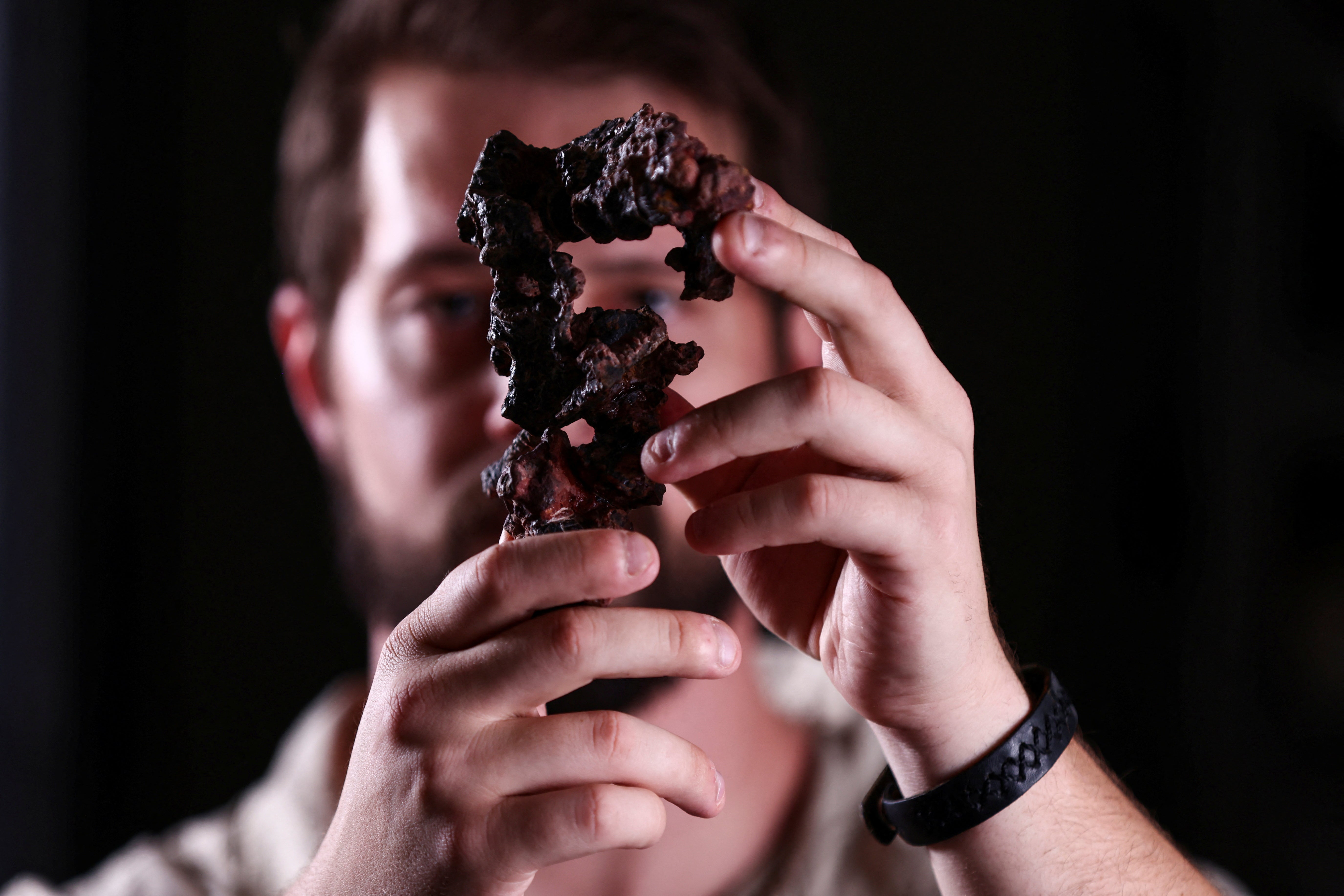 Paleontologist from the Federal University of Santa Maria, Rodrigo Temp Muller, holds a fossil