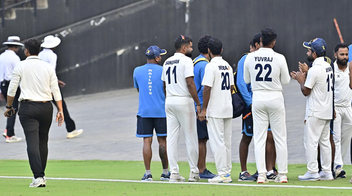 Railways team members ‘clap’ as the umpires leave the field at the end of the day-3 of the Ranji Trophy 2024-25 match between Railways and Tamil Nadu, at the Narendra Modi Stadium, in Ahmedabad on November 15, 2024.